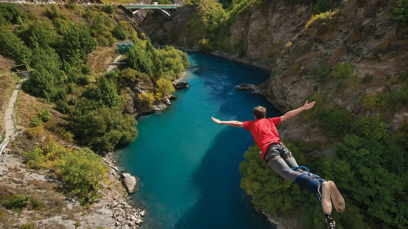 Back view of a person jumping off a bungy platform with water below at Kawarau Bridge, Queenstown, New Zealand. Image credit: Destination Queenstown