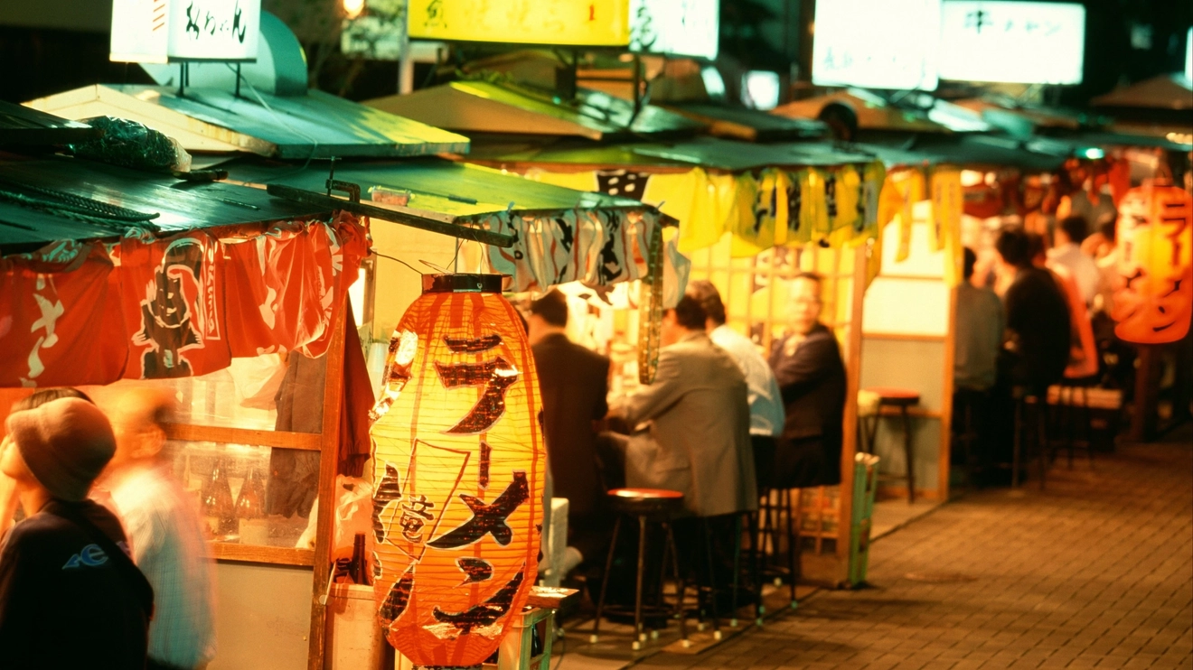 People dining at Nakasu food stalls at night, Fukuoka, Japan. Image credit: stock.adobe.com