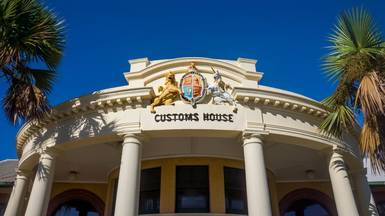 The exterior of Mackay Customs House, with columns and Queensland coat of arms. Image credit: IngeBlessas/Shutterstock.com