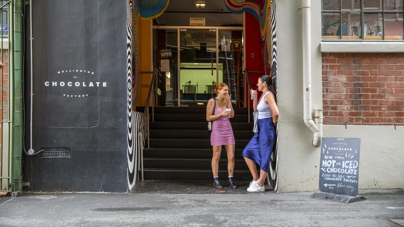 Two people standing in the doorway at Wellington Chocolate Factory, Hannahs Laneway, Wellington. Image credit: Camilla Rutherford