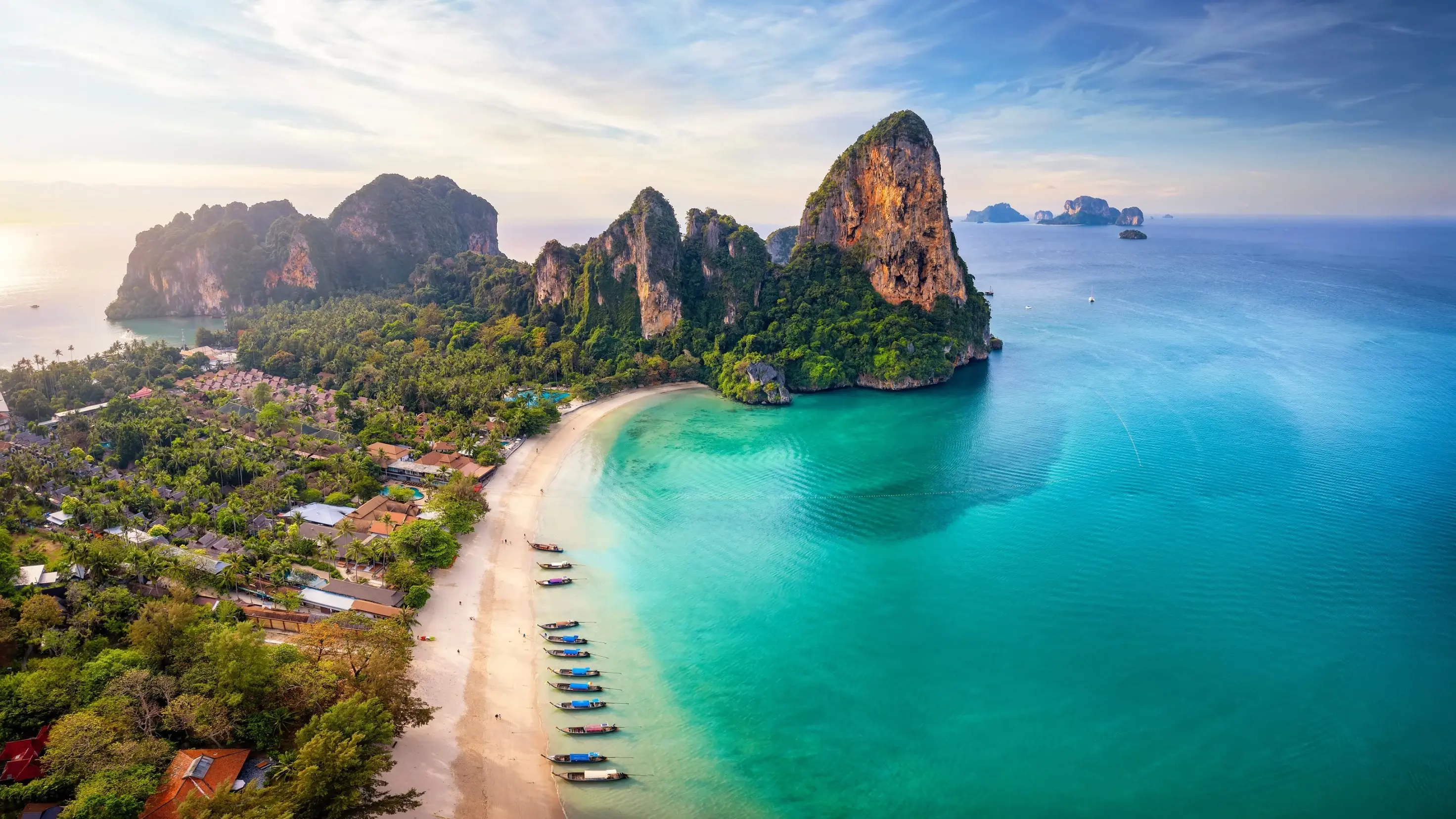 Aerial view of glorious Railay Beach, Krabi, with longtail boats parked along the shore and islands in background.&nbsp;Image credit: stock.adobe.com