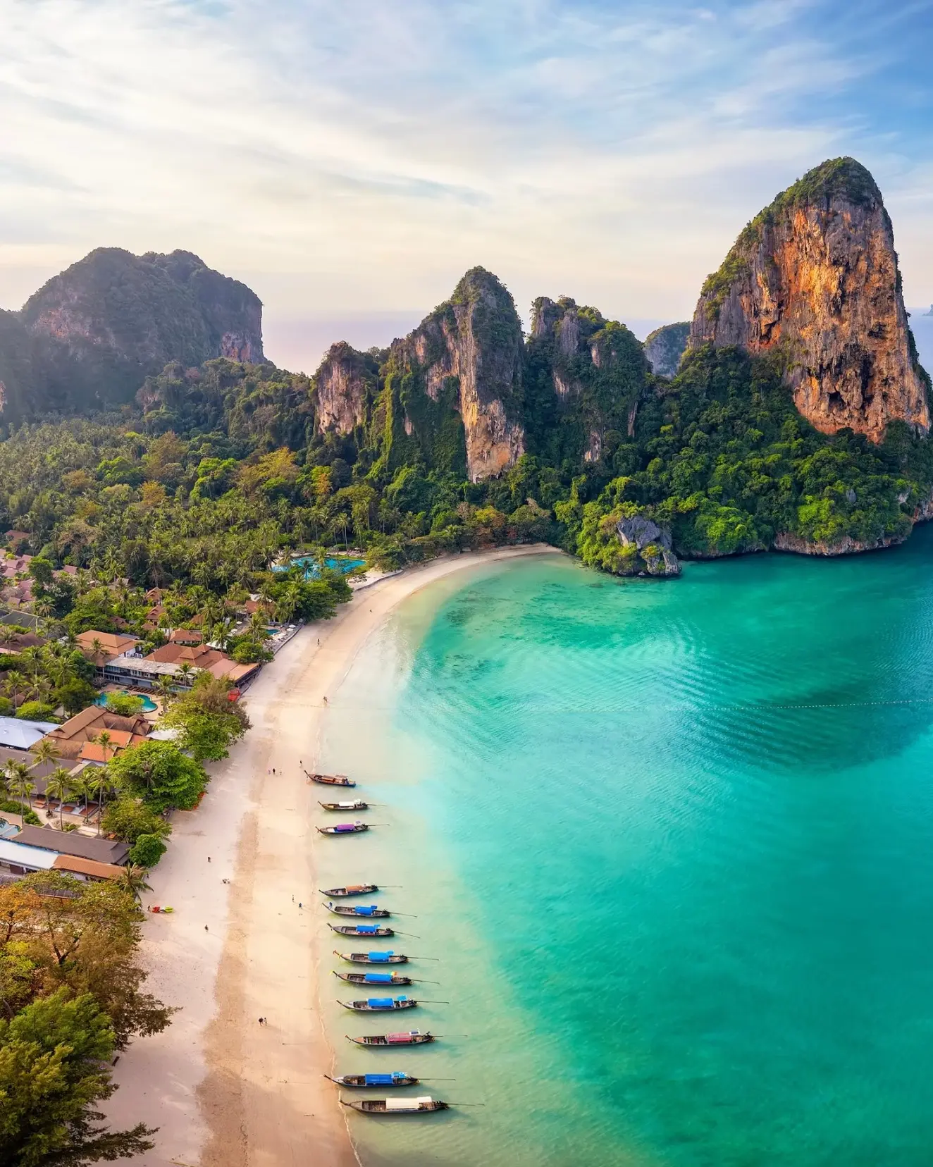 Aerial view of glorious Railay Beach, Krabi, with longtail boats parked along the shore and islands in background.&nbsp;Image credit: stock.adobe.com