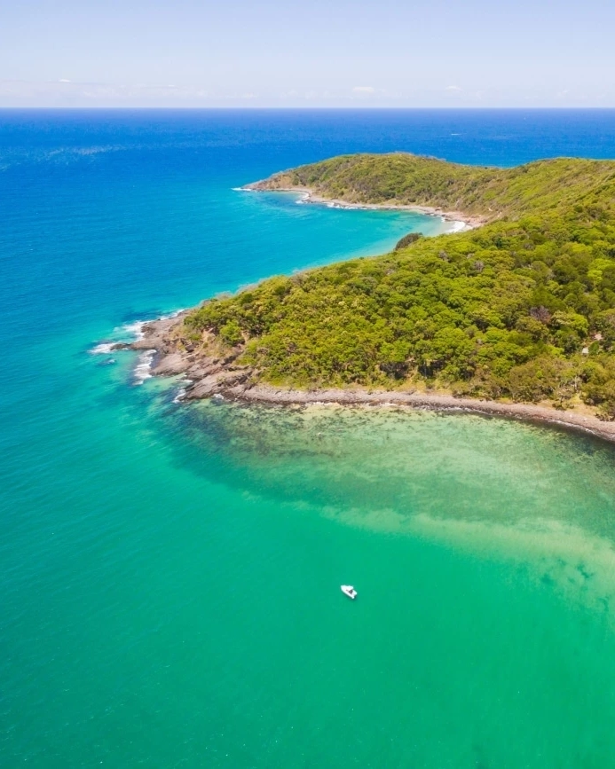 Aerial photograph of Main Beach and the surrounding forest in Noosa National Park, Sunshine Coast, Queensland, Australia. Image credit: bmphotographer/Shutterstock.com