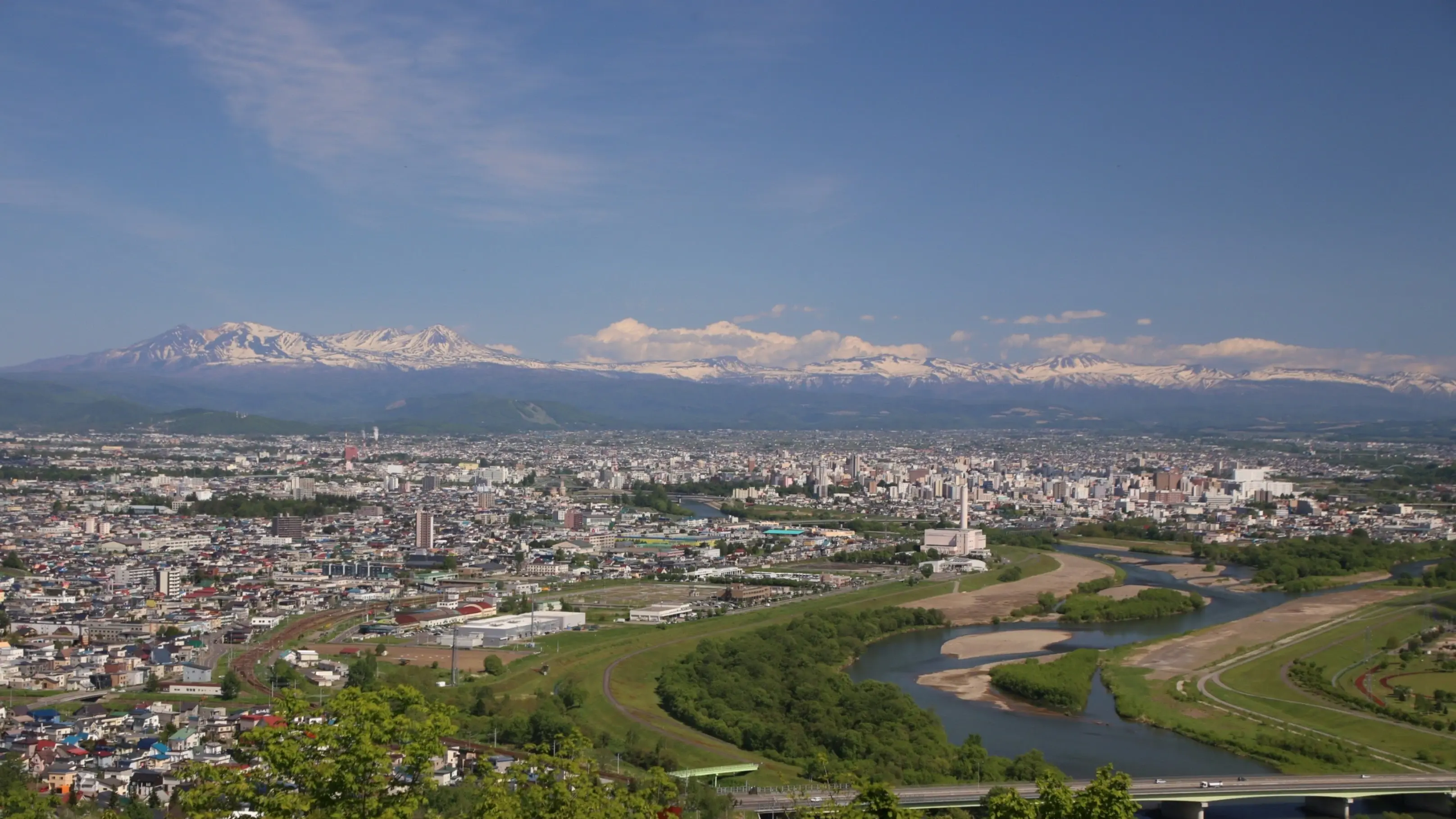 Asahikawa cityscape with snow-capped mountains in the background, Hokkaido, Japan. Image credit: Asahikawa City