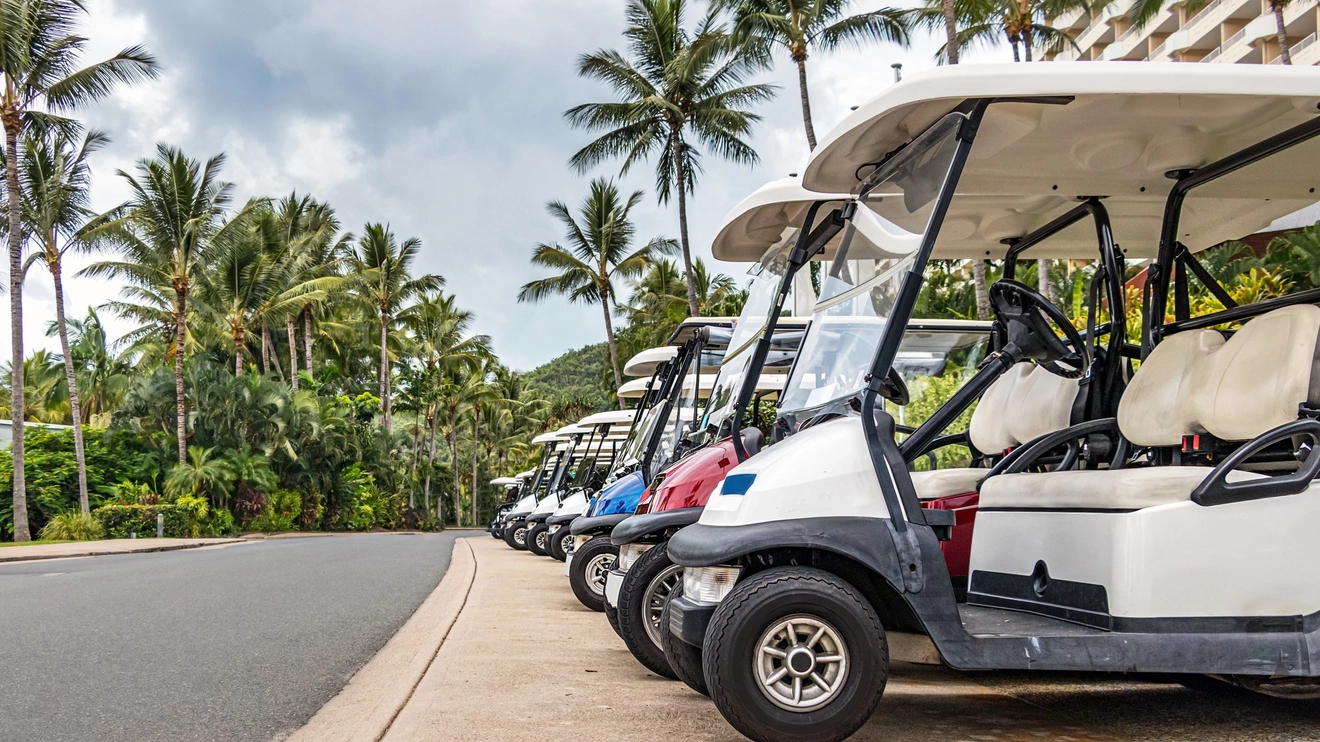 A row of golf buggies lined up in front of a hotel on Hamilton Island, Whitsunday Coast, Queensland. Image credit: Shutterstock