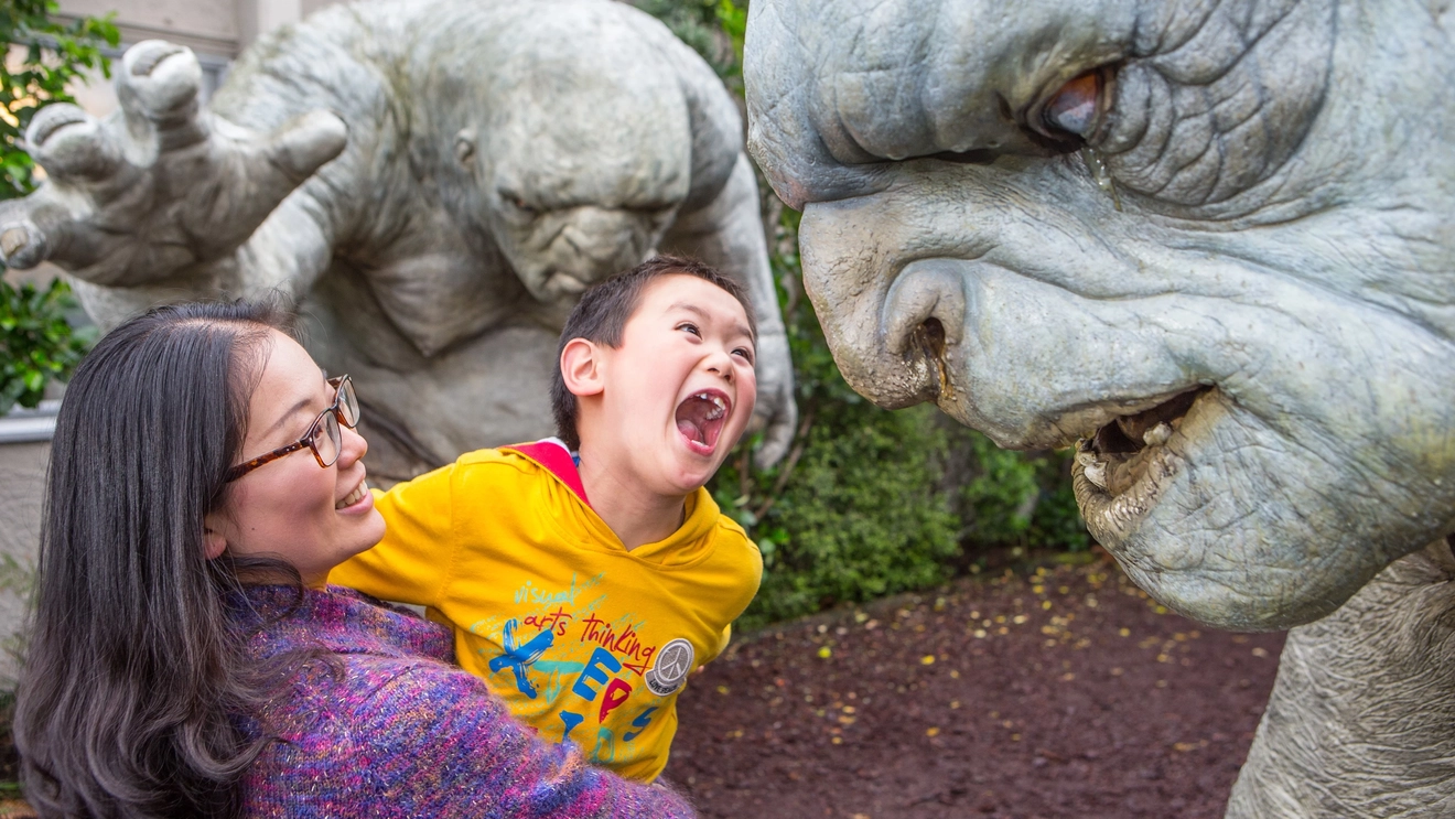 A small child and parent with troll sculptures at Wētā Workshop, Wellington, New Zealand. Image credit: WellingtonNZ