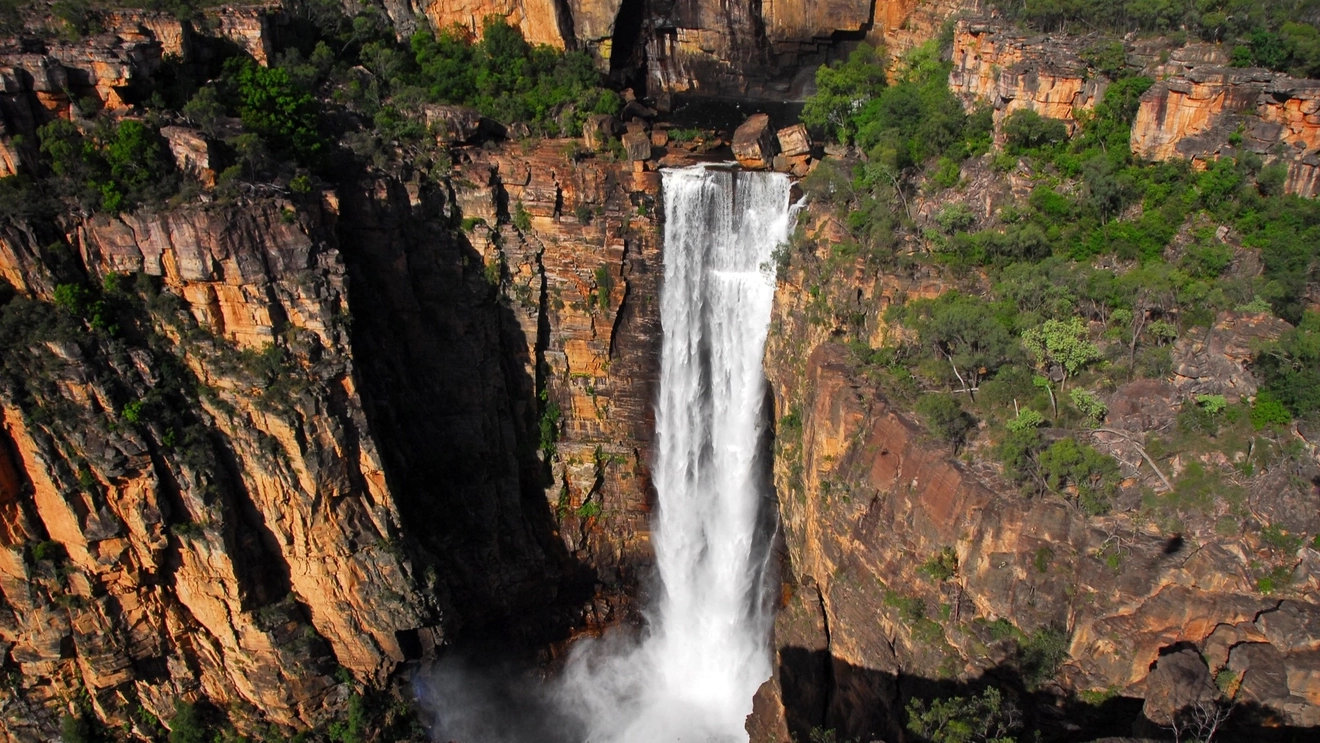 Aerial view of Jim Jim Falls in the wet season, tumbling over 200-metre drop down an escarpment in Kakadu National Park.