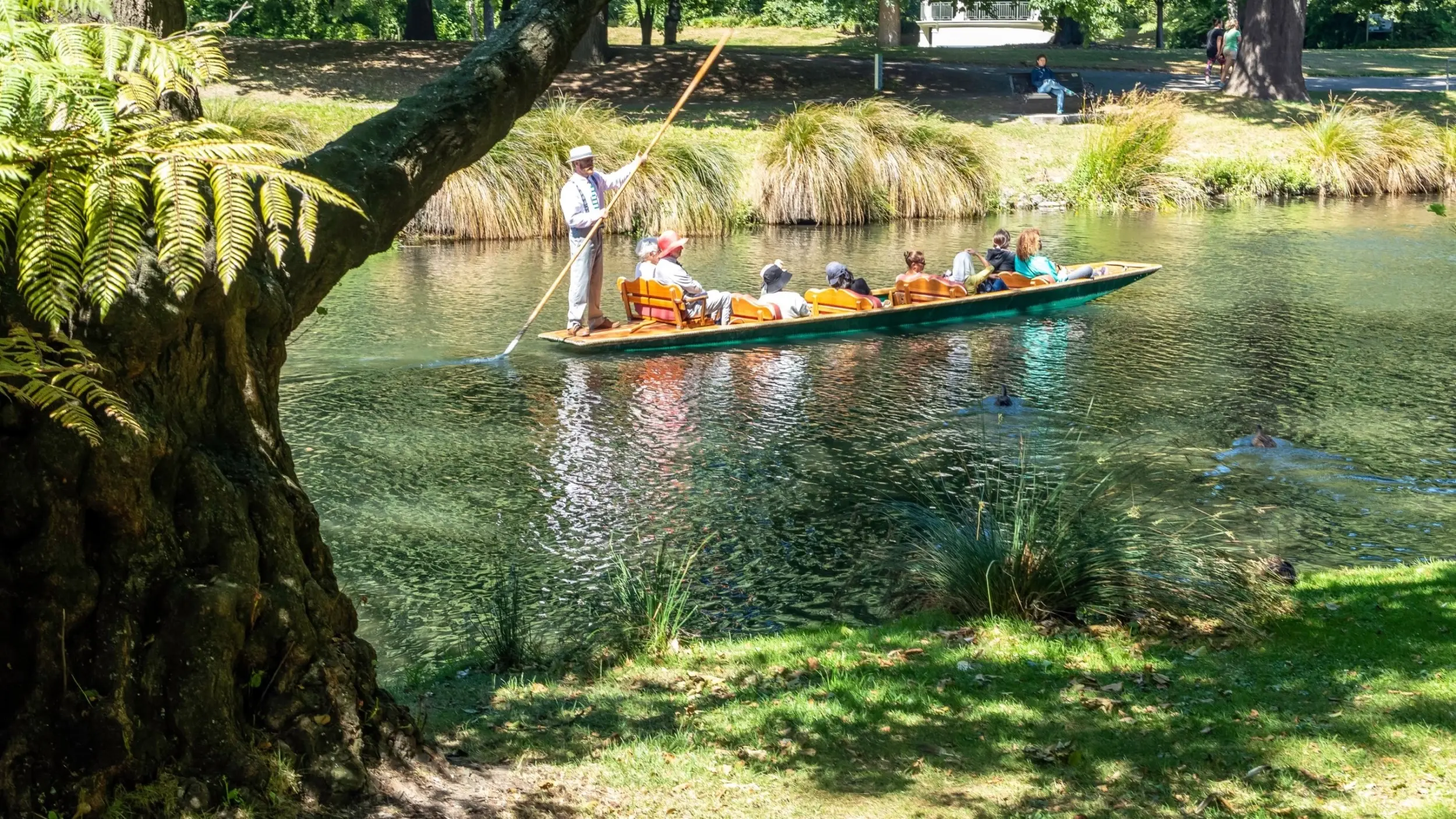 A group of people go punting along the Avon River past the Christchurch Botanic Gardens, Christchurch, New Zealand. Image credit: stock.adobe.com