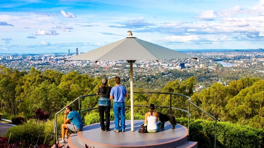 Tourists at viewing platform on Mt. Coot-tha in Queensland Australia looking down on Brisbane