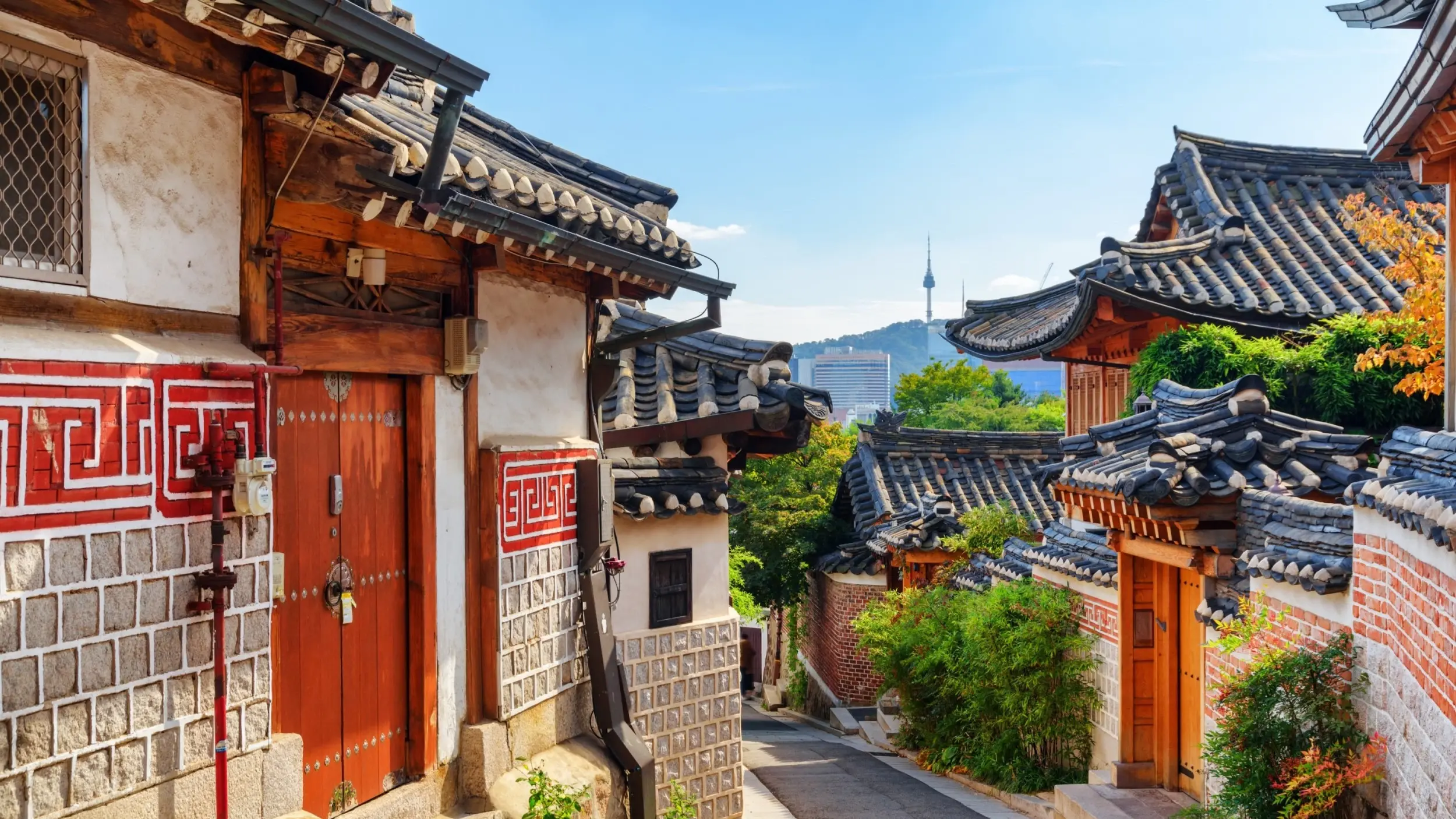 Laneway of traditional Korean houses with N Seoul Tower on the skyline. Image credit: stock.adobe.com