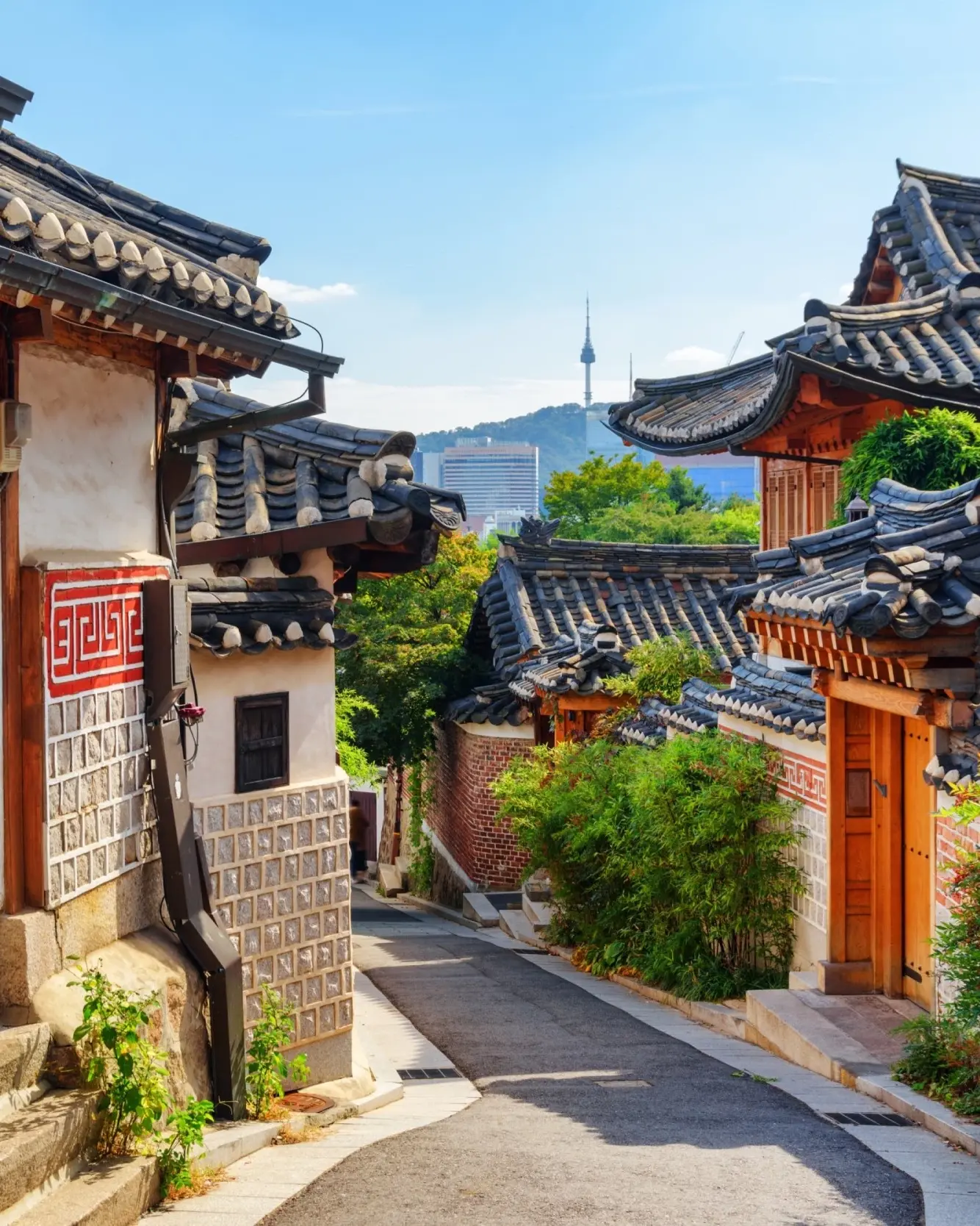 Laneway of traditional Korean houses with N Seoul Tower on the skyline. Image credit: stock.adobe.com