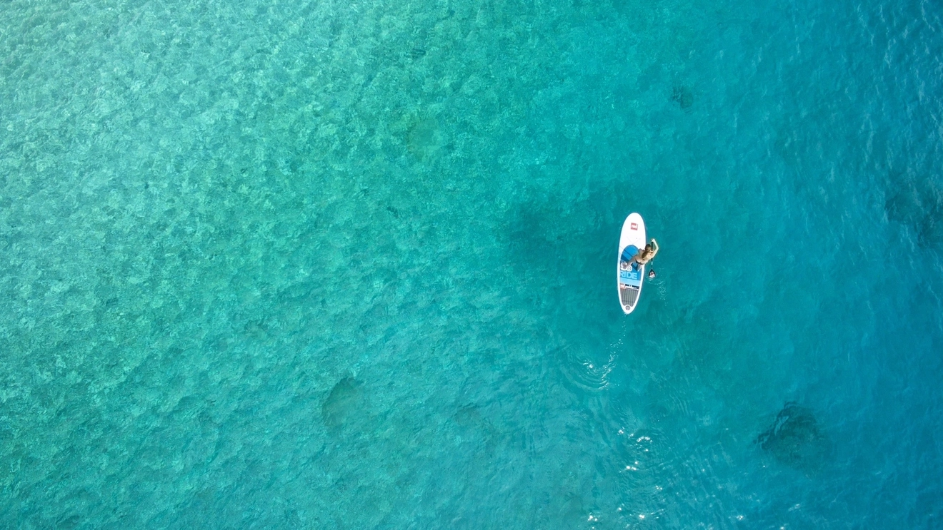 Paddle boarding on a lagoon.