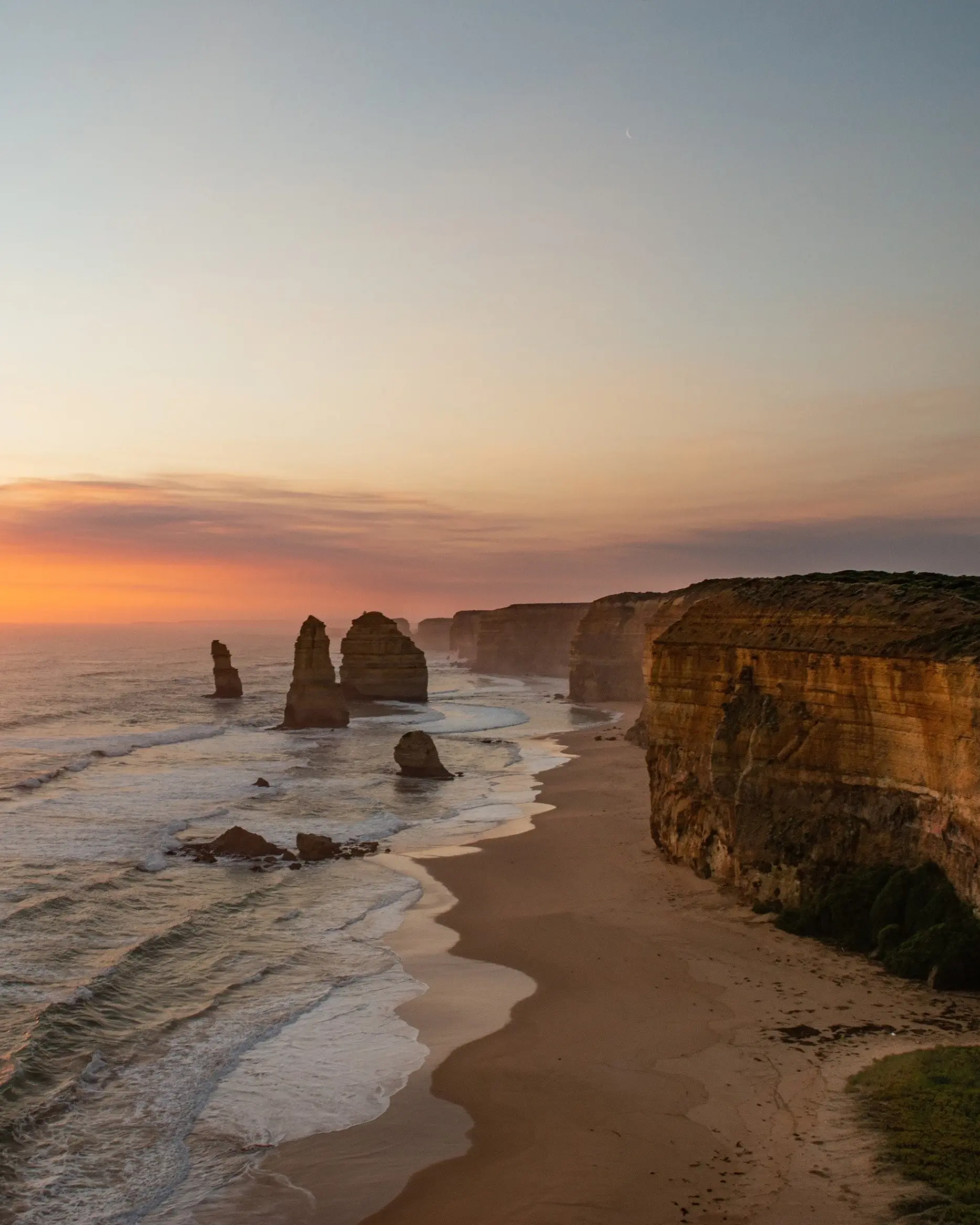 The Twelve Apostles, on the Great Ocean Road, looking mysterious against the sunset. Image credit: Visit Victoria