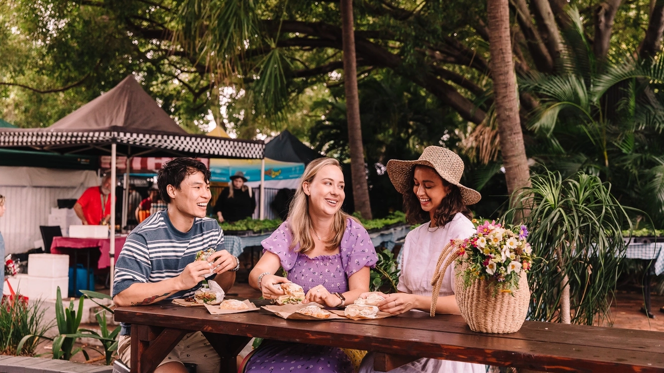 Three friends enjoying some market food at Brisbane’s West End Markets. Image credit: Tourism and Events Queensland