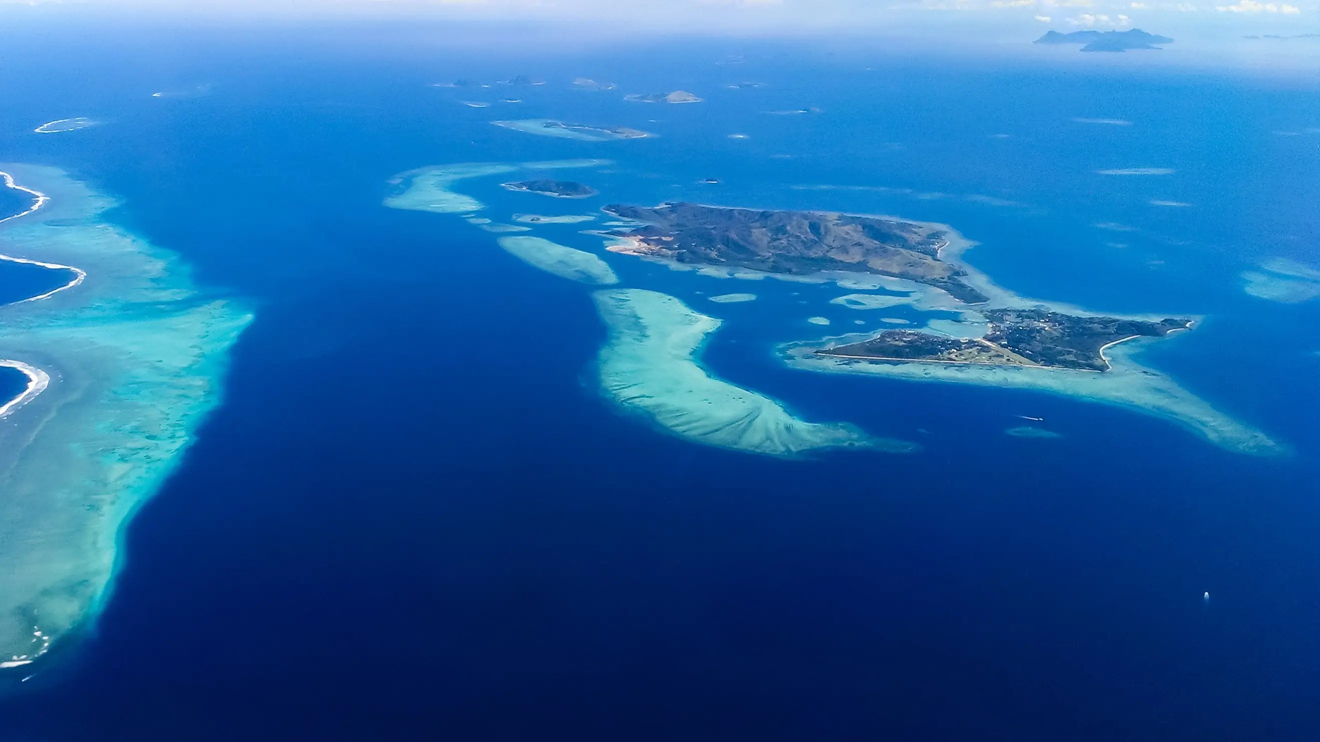 Aerial view of Fiji's Mamanuca Islands surrounded by blue ocean. Image credit: stock.adobe.com