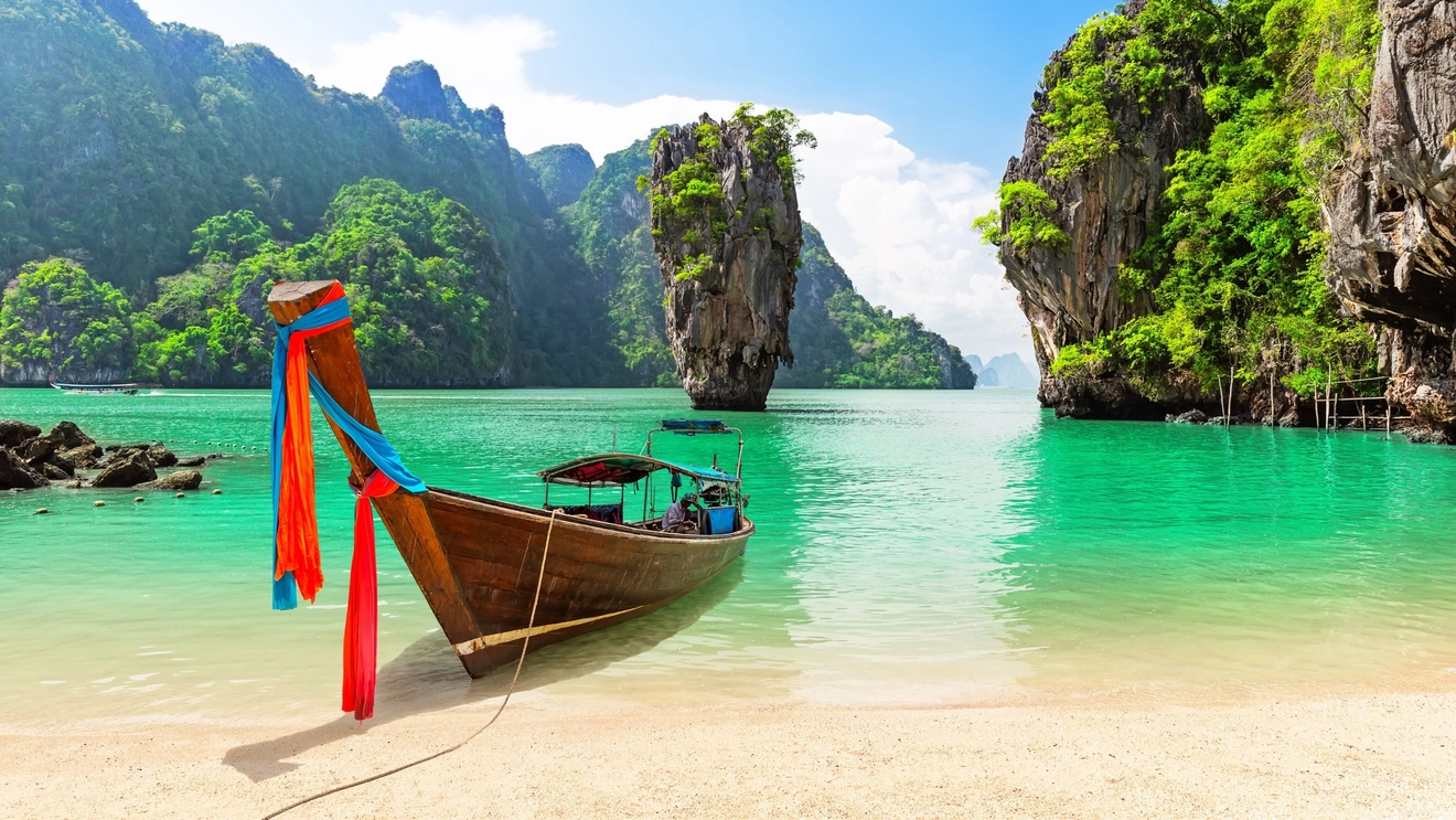 ‘James Bond Island’ Koh Tapu, with longtail boat on the beach, Ao Phang Nga, Thailand. Image credit: stock.adobe.com