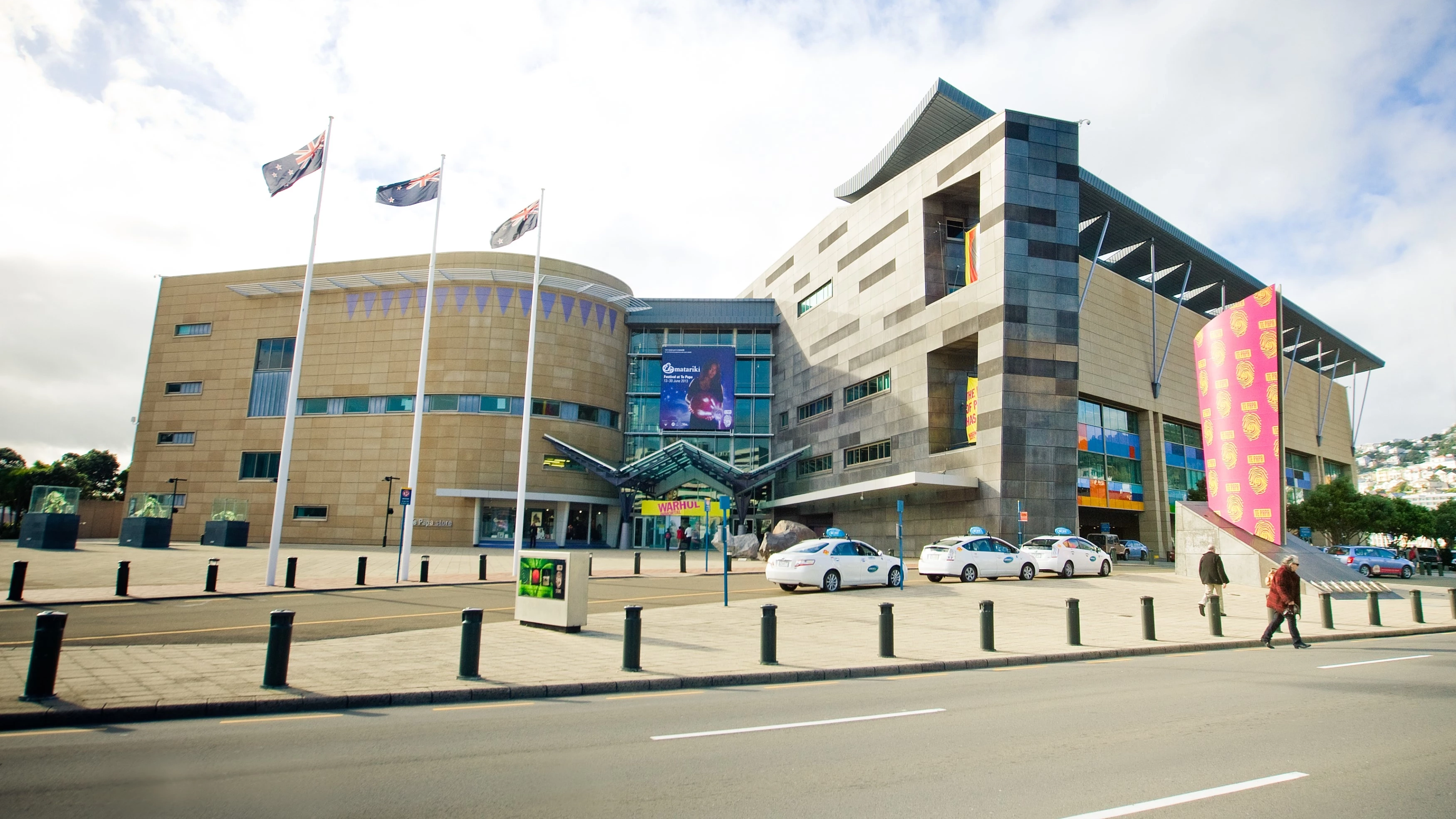 The front of Te Papa Museum with a road and several taxis in the foreground, Wellington, New Zealand. Image credit: WellingtonNZ