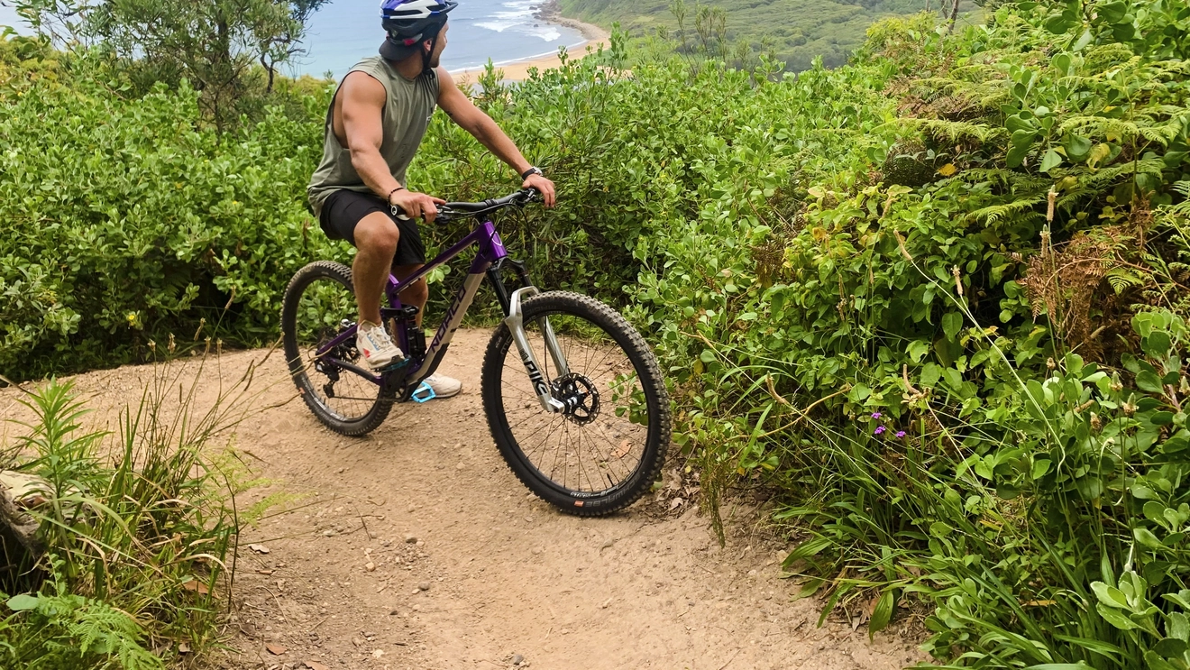 Man riding a mountain bike through Glenrock State Conservation Area, near Newcastle. Image credit: Destination NSW