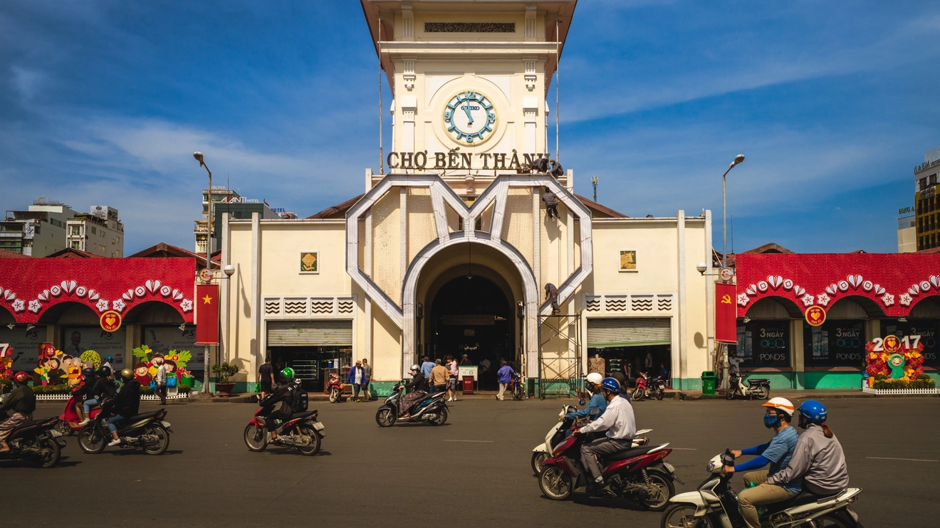 Cyclists whizz past the Ben Thanh Market, Ho Chi Minh City, Vietnam. Image credit: Richie Chan - stock.adobe.com