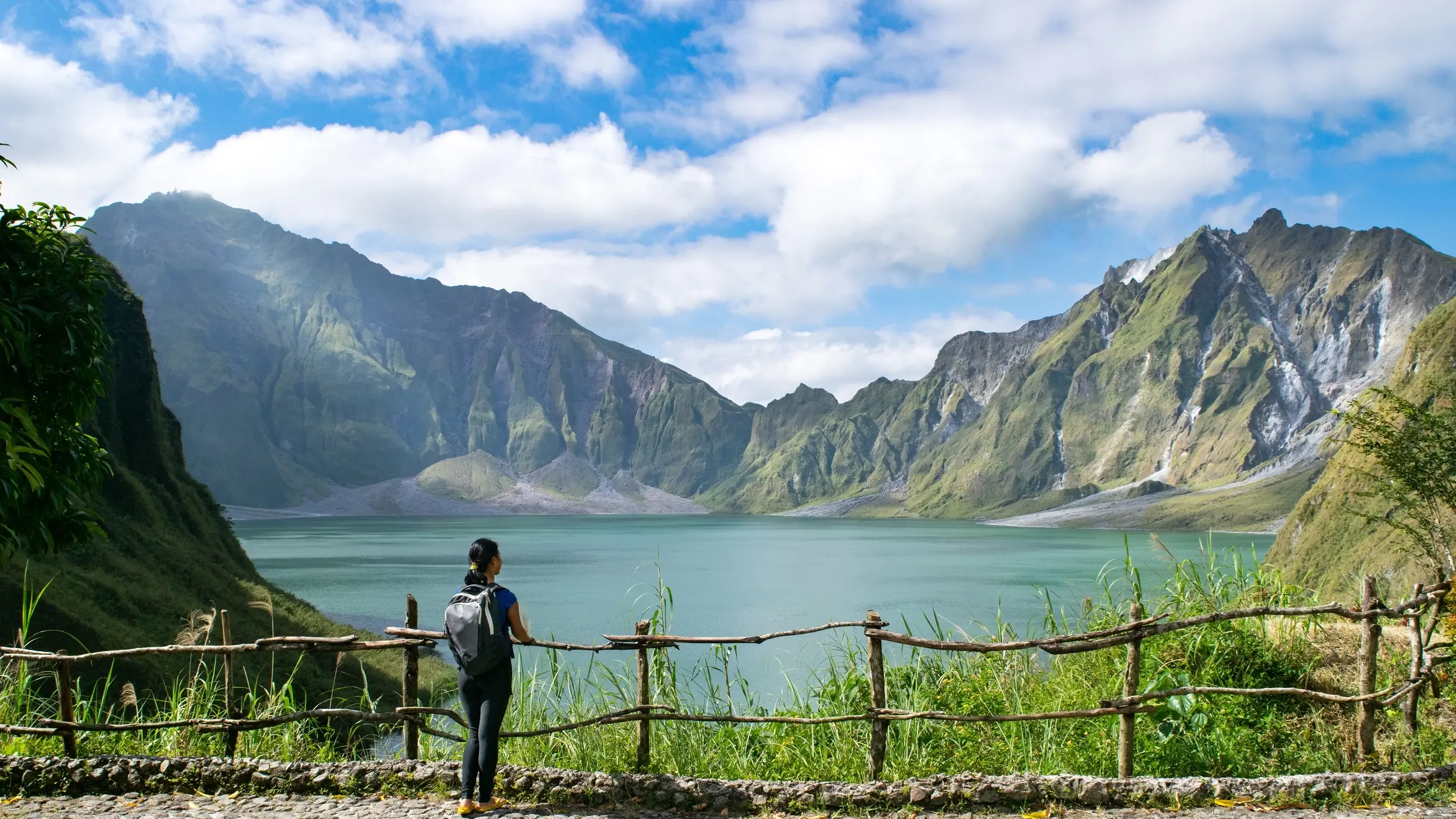 Female tourist admires the crater lake at the peak of Mount Pinatubo, near Clark in the Philippines. Image credit: stock.adobe.com