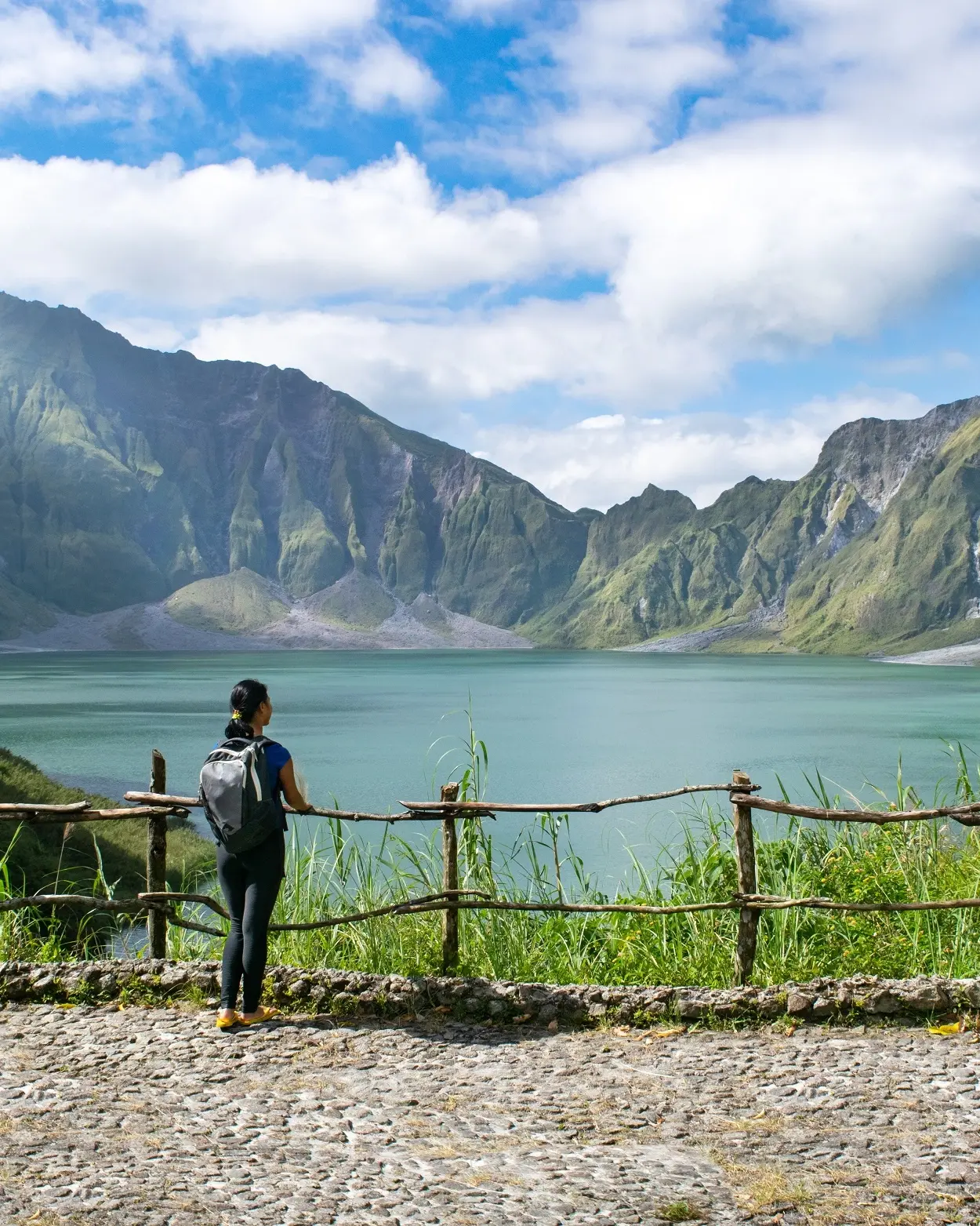 Female tourist admires the crater lake at the peak of Mount Pinatubo, near Clark in the Philippines. Image credit: stock.adobe.com