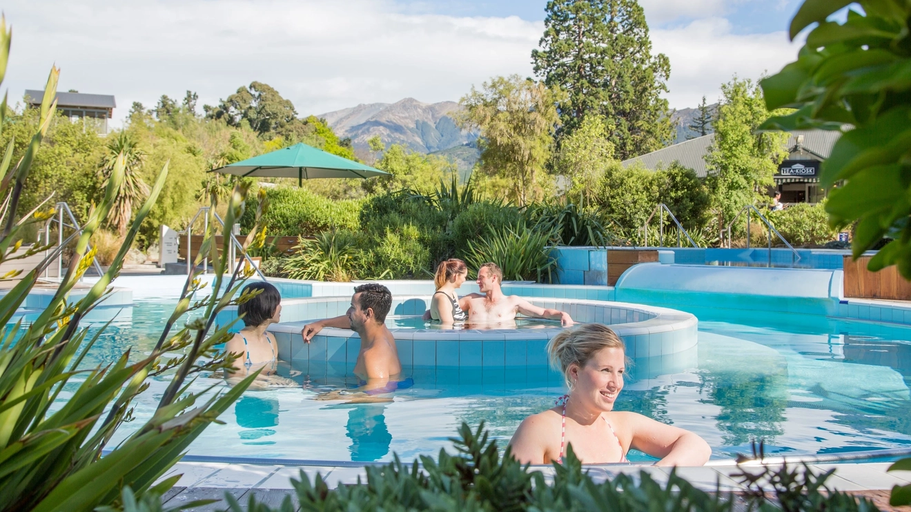People relaxing in a series of hot pools at Hanmer Springs, New Zealand. Image credit: Hanmer Springs