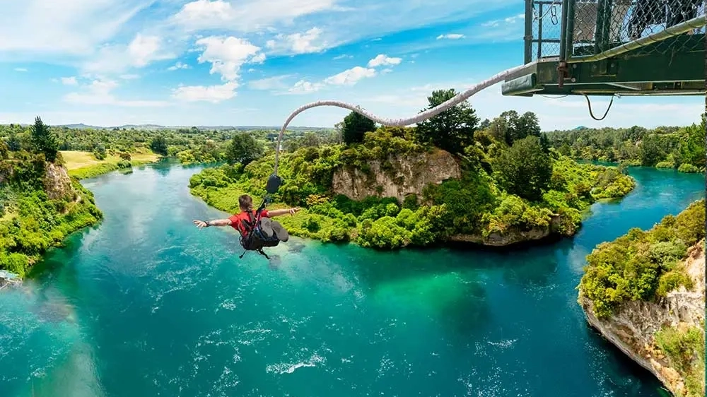 Person bungy jumping over a river in Taupo, NZ.