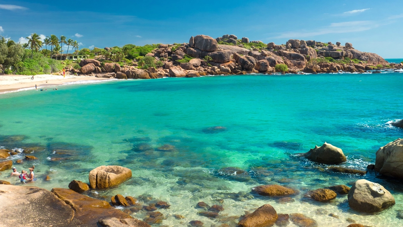 People swimming in the shallows at a Bowen beach, Whitsunday Coast. Image credit: Tourism and Events Queensland