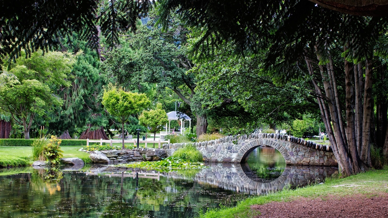 A stone bridge over a lake in the Queenstown Gardens, New Zealand. Image credit: stock.adobe.com