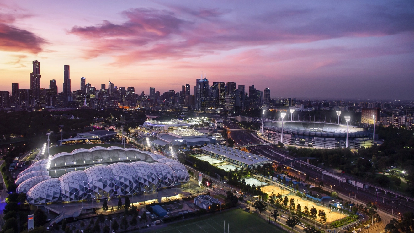 Aerial view of Melbourne's sports precinct at night: AAMI Park, Melbourne Park and the MCG. Image credit: Visit Victoria