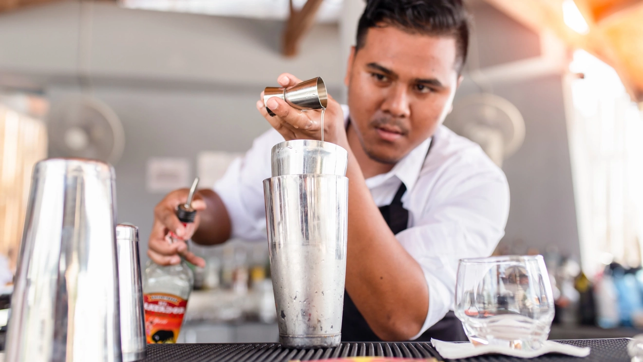 Close-up of a bartender pouring cocktail in a bar, Phuket, Thailand. Image credit: stock.adobe.com