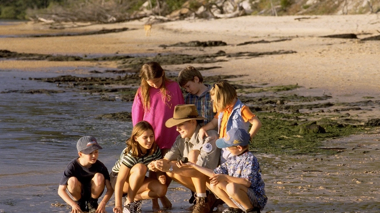 An instructor shows a group of children the marine life at Kingfisher Bay.