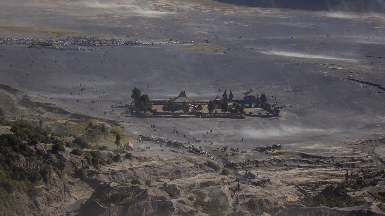 A distant view of the Pura Luhur Poten, a Hindu temple, in the Sea of Sand of Bromo, Surabaya, Indonesia. Image credit: stock.adobe.com