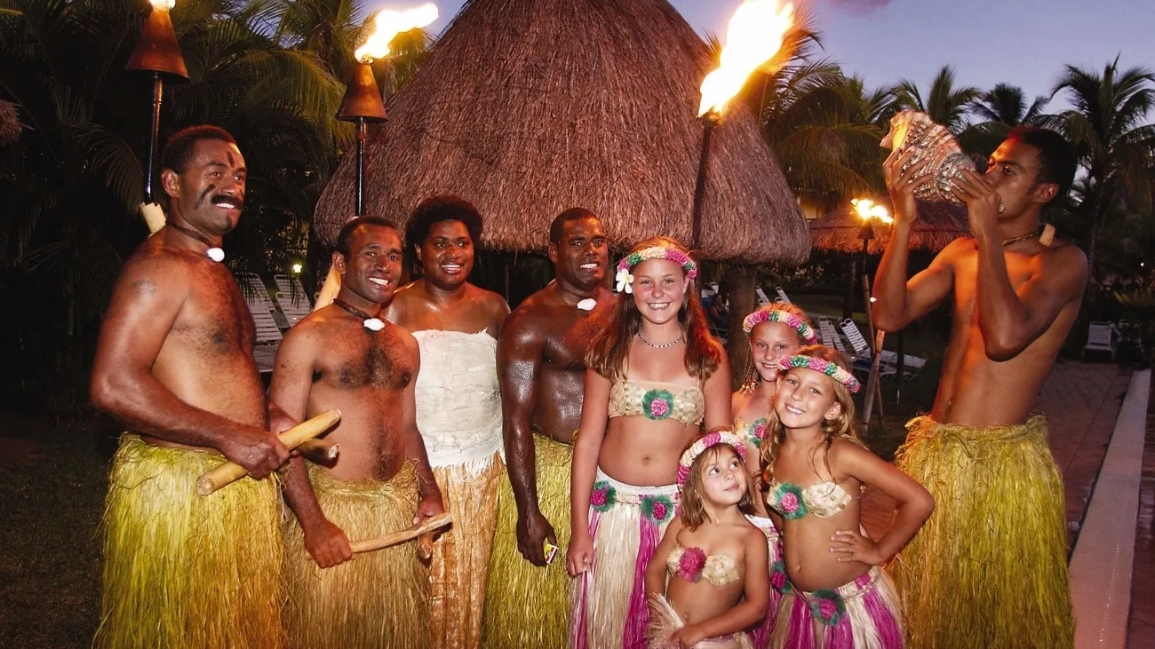 Kids dressed in Fijian costume enjoy a traditional torch ceremony