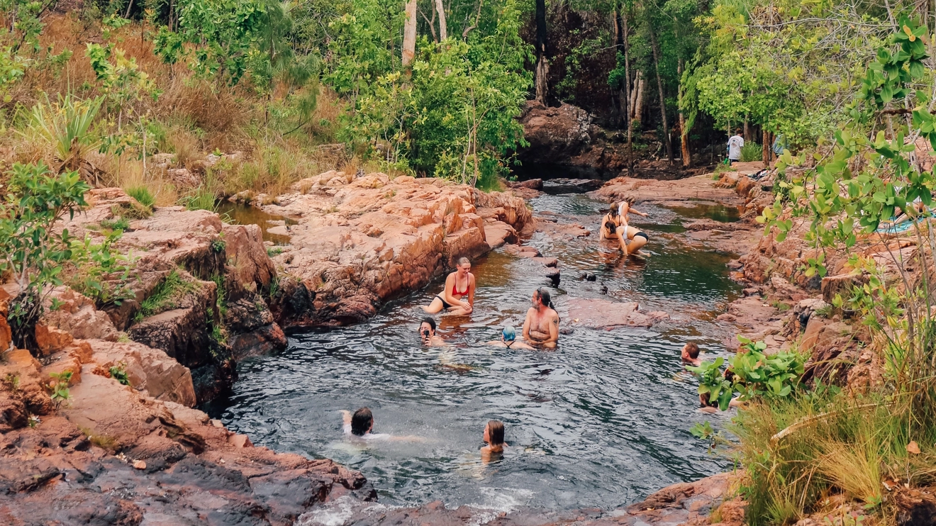 A group of people swimming at Buley Rockhole in Litchfield National Park. Image credit: Tourism NT/Lucy Ewing