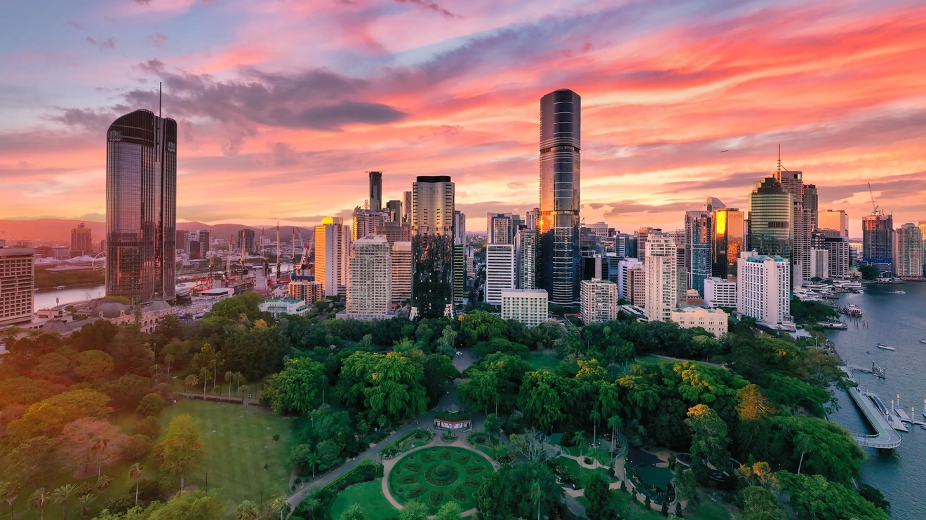 Aerial view of Botanic Gardens, Brisbane River and Brisbane CBD skyline at sunset. Image credit: Tourism and Events Queensland