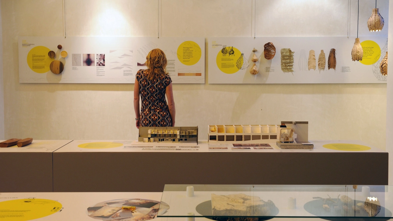 The back view of a person looking at framed artworks at Design Tasmania, Launceston. Image credit: Tourism Tasmania/Chris Crerar