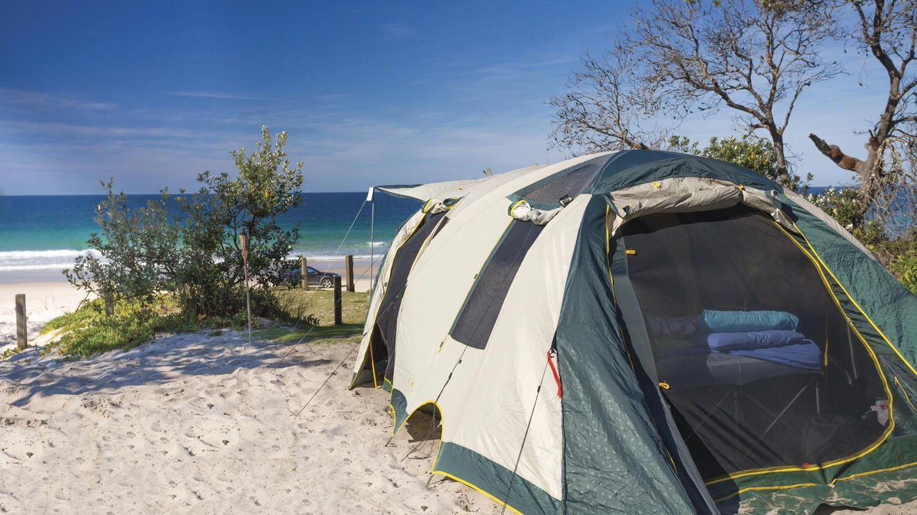 A tent pitched overlooking the beach at Ocean Beach Camping Area 16, Coochin Creek, Sunshine Coast. Image credit: Tourism and Events Queensland/Larissa Dening