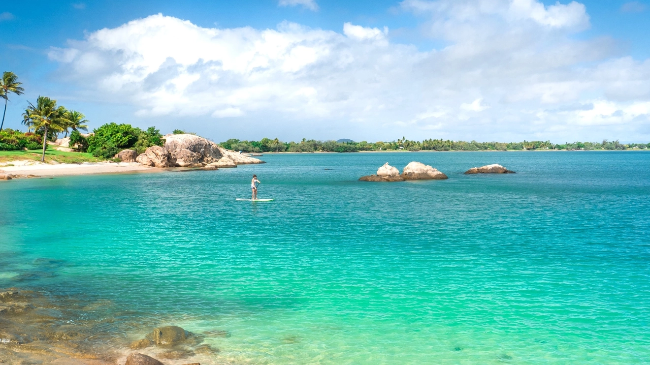 Person on SUP at secluded beach at Bowen, Whitsunday Coast. Image credit: Tourism and Events Queensland