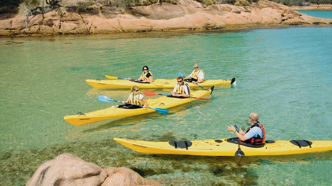 Kayaks on the clear calm waters of Coles Bay, Freycinet.