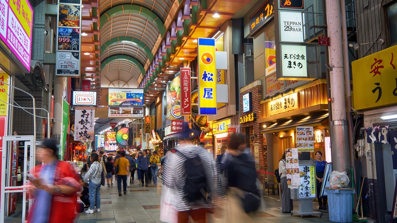 Interior view of people shopping at Doguya-suji Arcade, a covered shopping arcade in Osaka, Japan. Image credit: Serg Zastavkin – stock.adobe.com