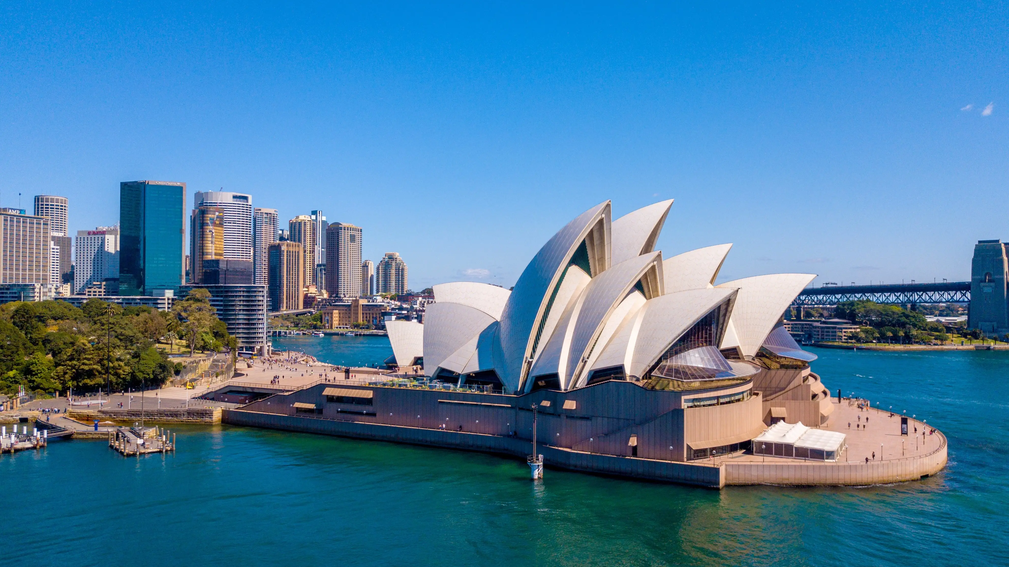 Sydney Opera House surrounded by the harbour on a sunny day. Image credit: stock.adobe.com/ingusk