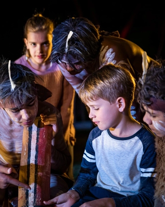 Kids learn about the didgeridoo at the Spirits of the Red Sand experience. Queensland is full of opportunities to delve into the diverse culture of Aboriginal Australia. Image credit: Archie Sartracom/Tourism Australia