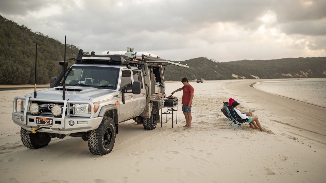 Family camping on the beach with their 4WD, Double Island Point, Great Sandy National Park. Image credit: Tourism and Events Queensland