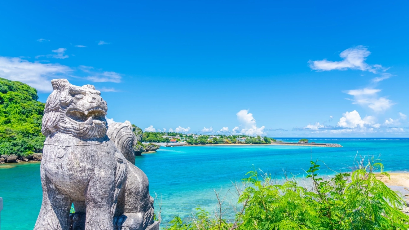 Stone-carved Shisa with Okinawa Sea in the background, Okinawa, Japan. Image credit: stock.aobe.com