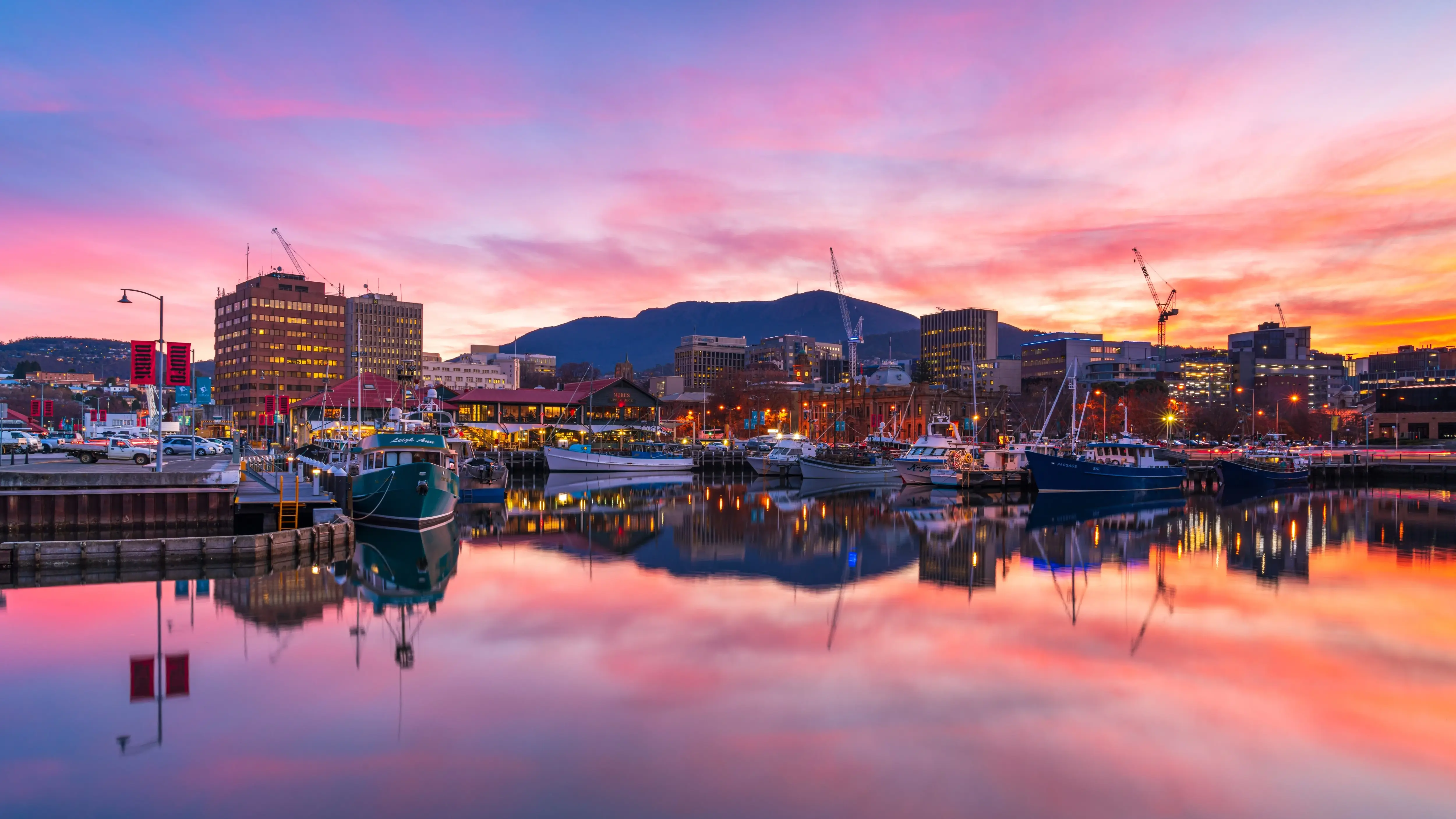 Hobart waterfront at sunset with city skyline and fishing boats. Image credit: Tourism Tasmania/Luke Tscharke