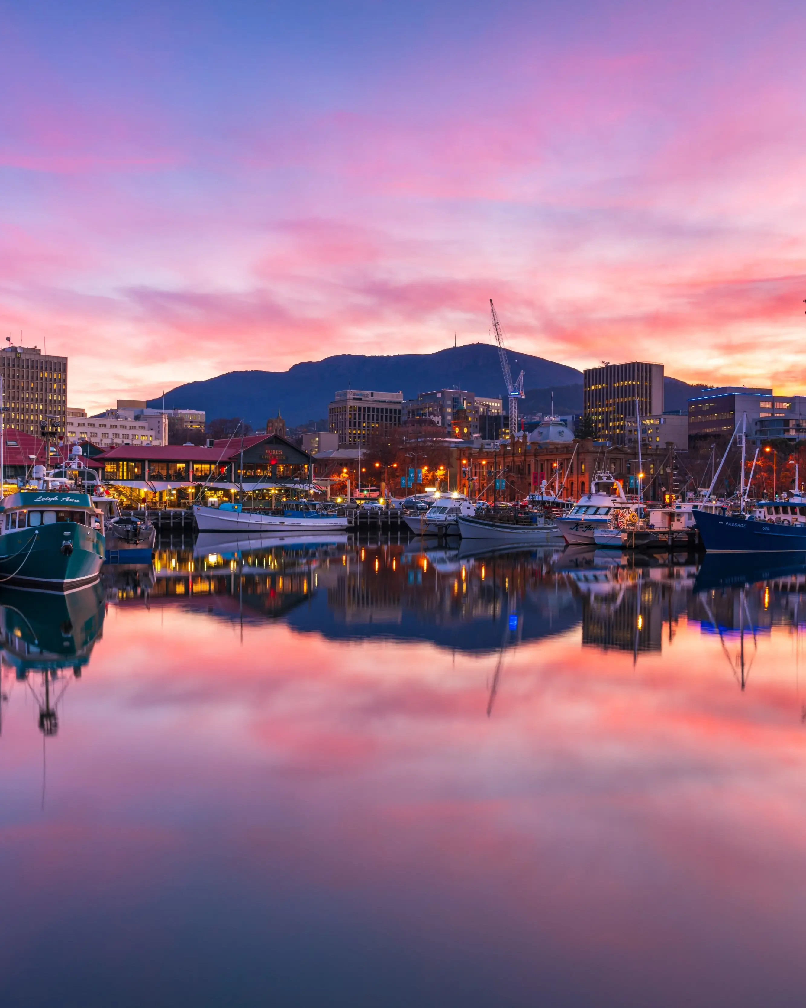 Hobart waterfront at sunset with city skyline and fishing boats. Image credit: Tourism Tasmania/Luke Tscharke