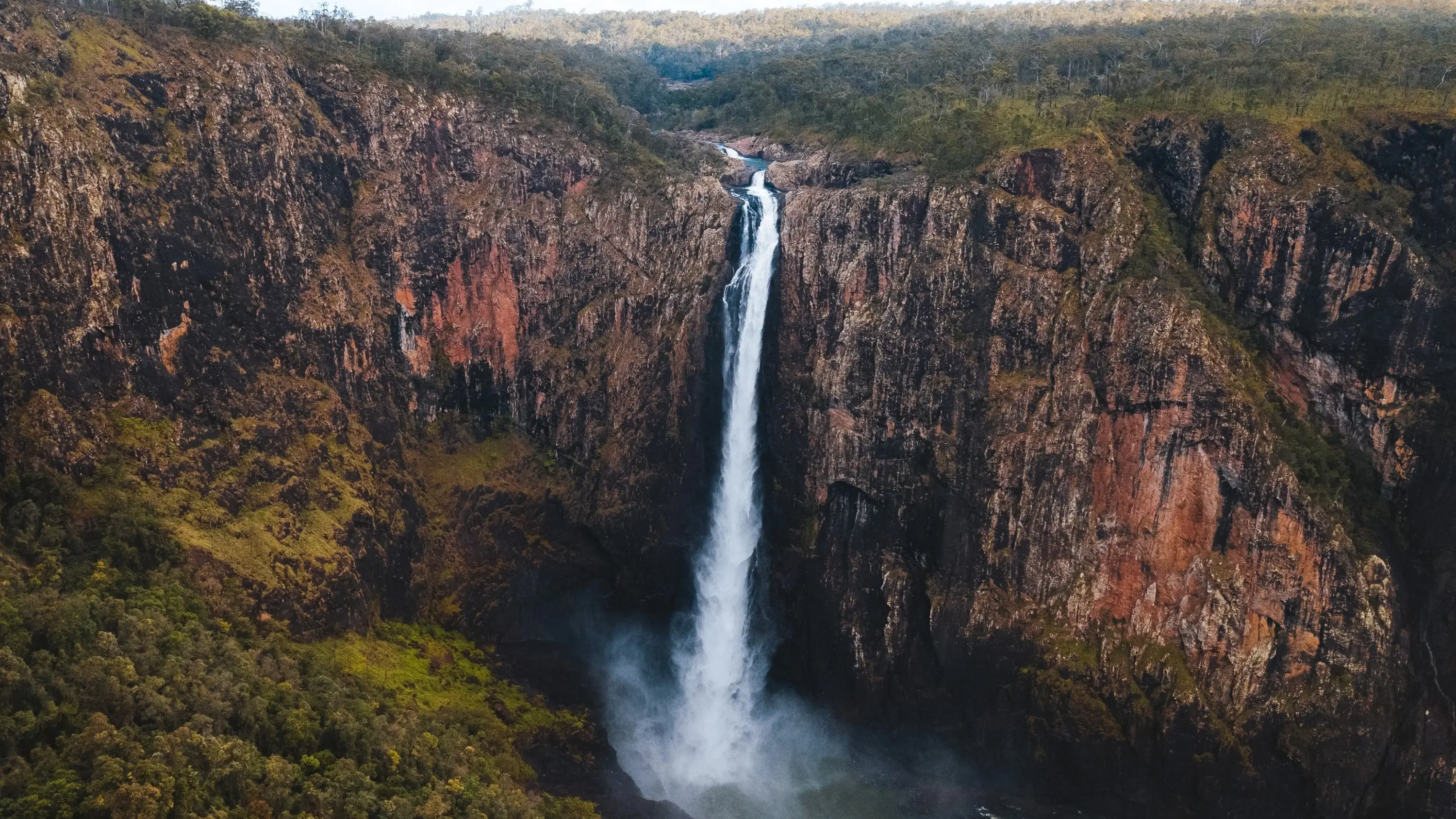 Aerial view of Wallaman Falls, a 268-metre single-drop waterfall surrounded by cliffs. Image credit: Tourism and Events Queensland