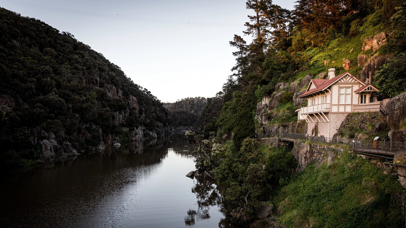 The steep banks and river at Launceston's Cataract Gorge, with a building on the right bank. Image credit: Tourism Tasmania/Nat Mendham