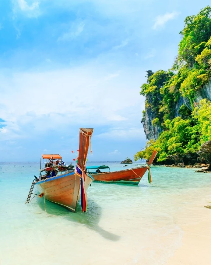 Longtail boats on the white-sand beach at Phuket, Thailand. Image credit: stock.adobe.com